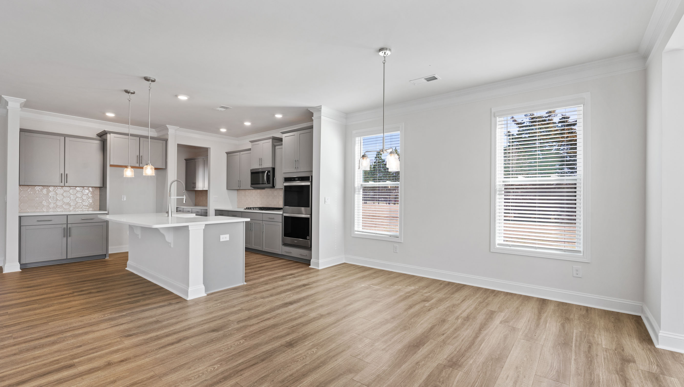 View of breakfast area with large windows facing kitchen.