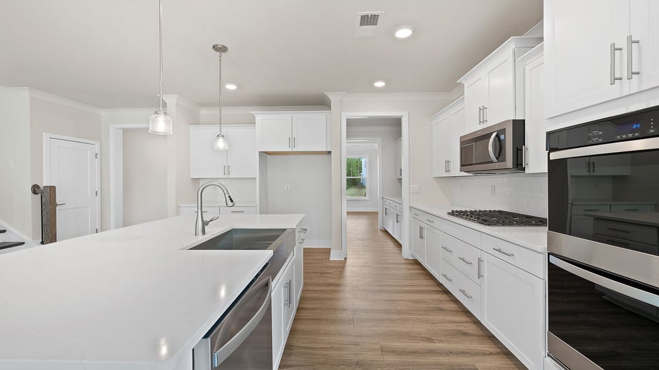 Kitchen with island and quartz countertops.