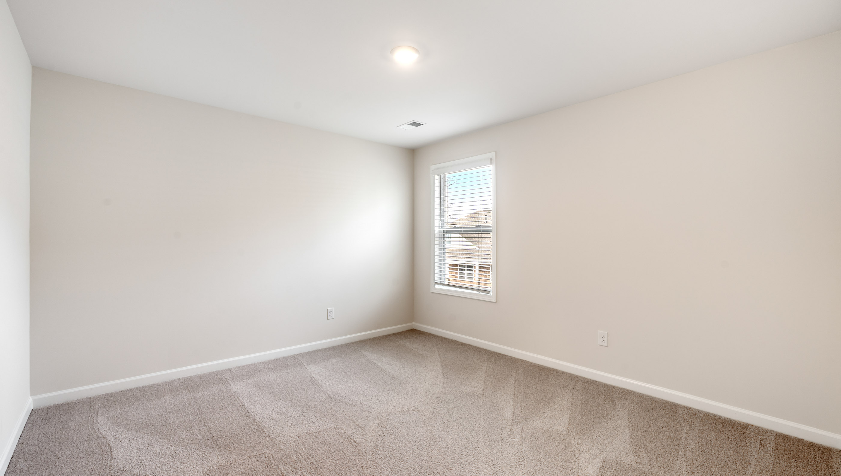 Bedroom with carpet window.