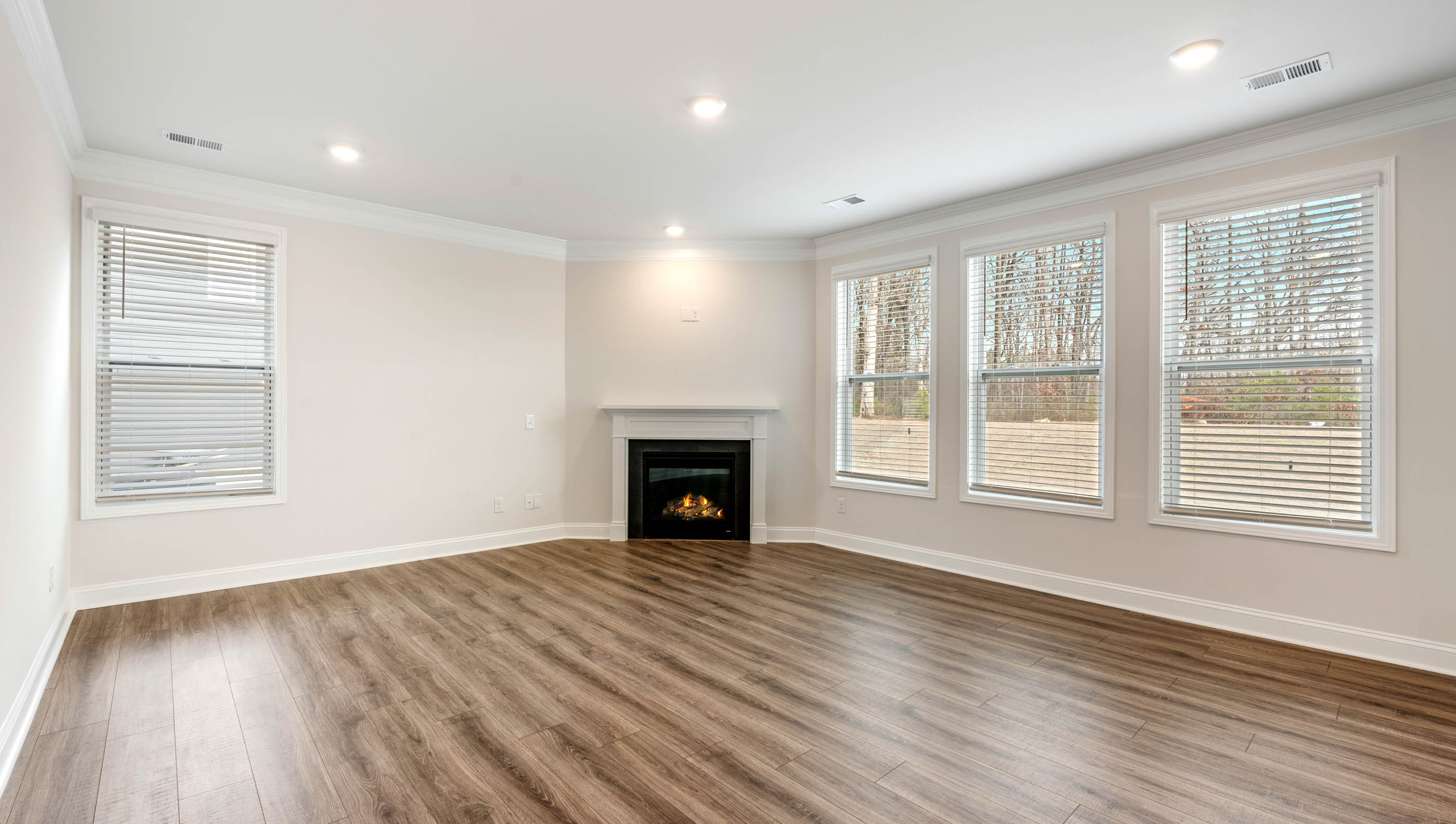 Family room with fireplace and windows.