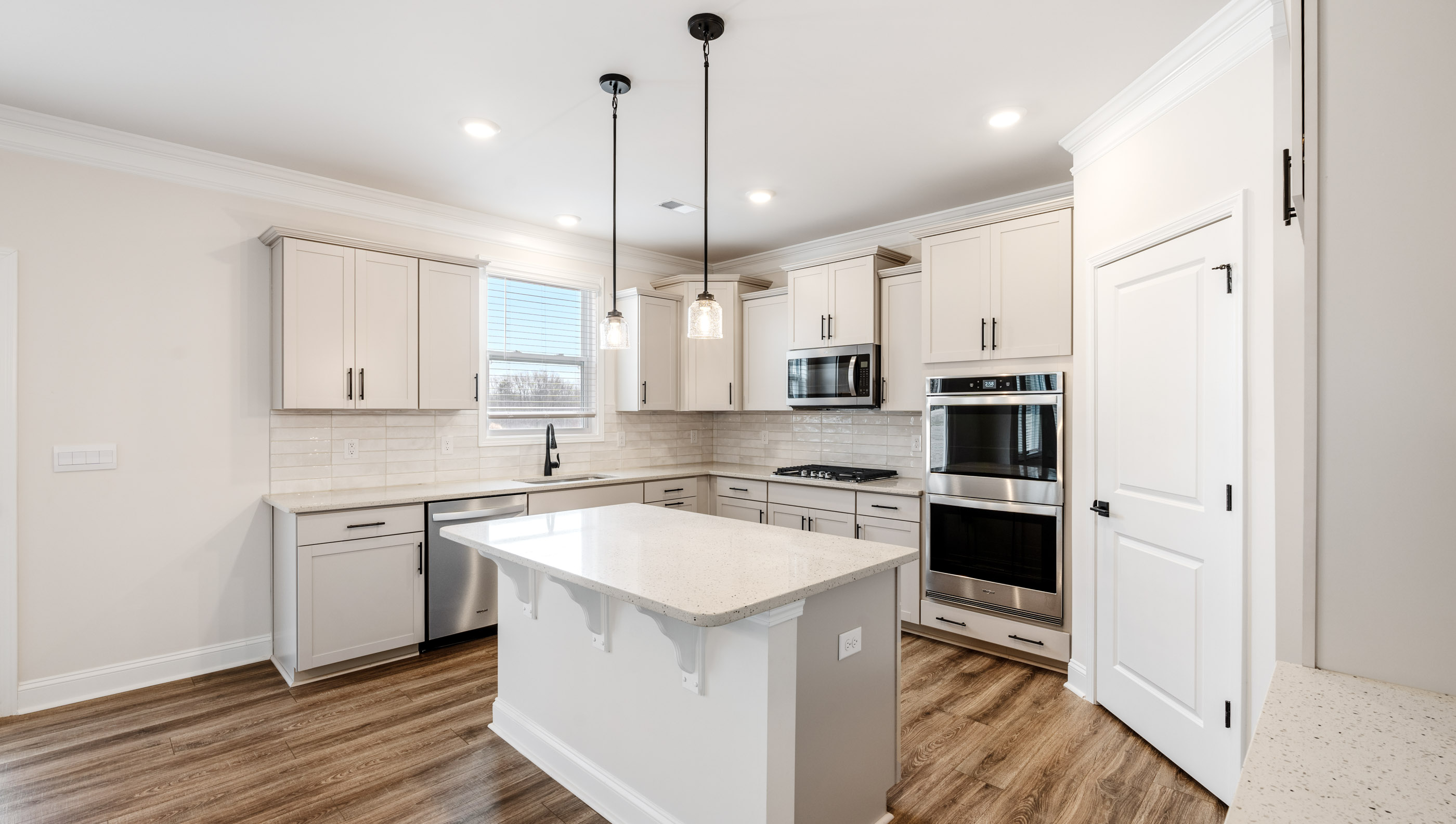 Kitchen with island and quartz countertops.