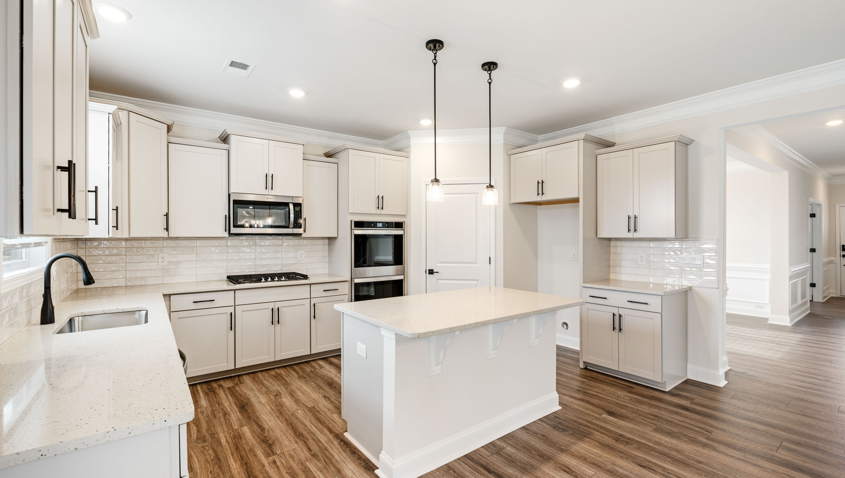 Kitchen with island and quartz countertops.