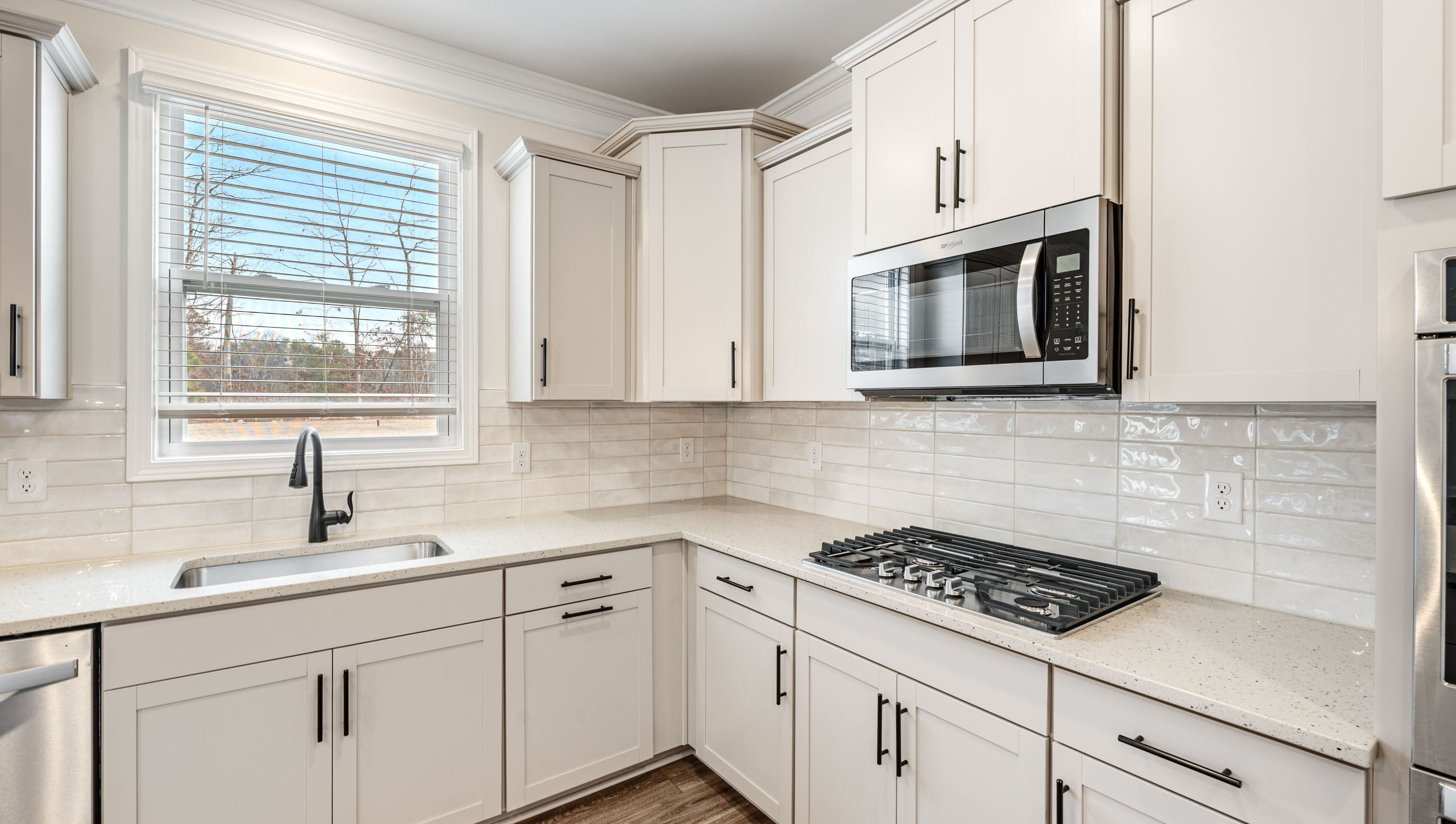 Kitchen with quartz countertops and stainless steel appliances.