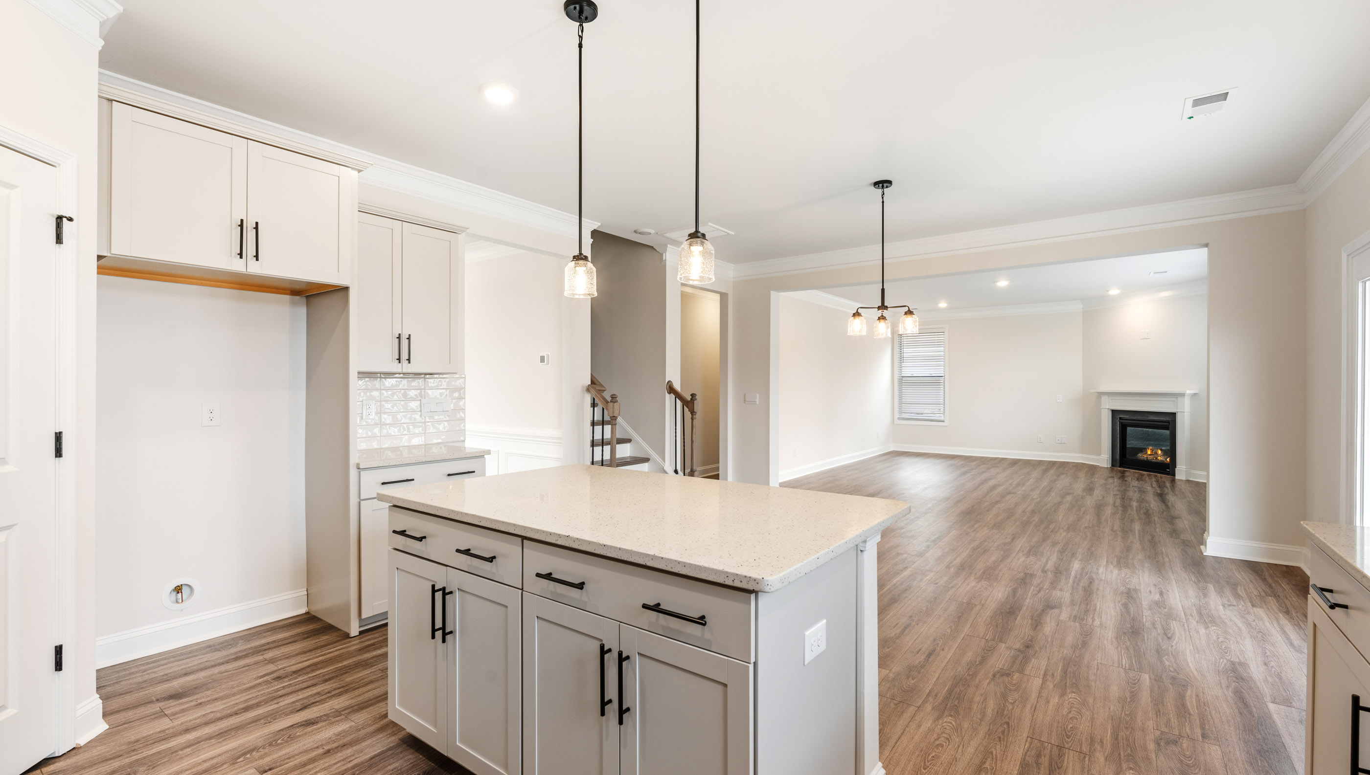 Kitchen with island and quartz countertops.