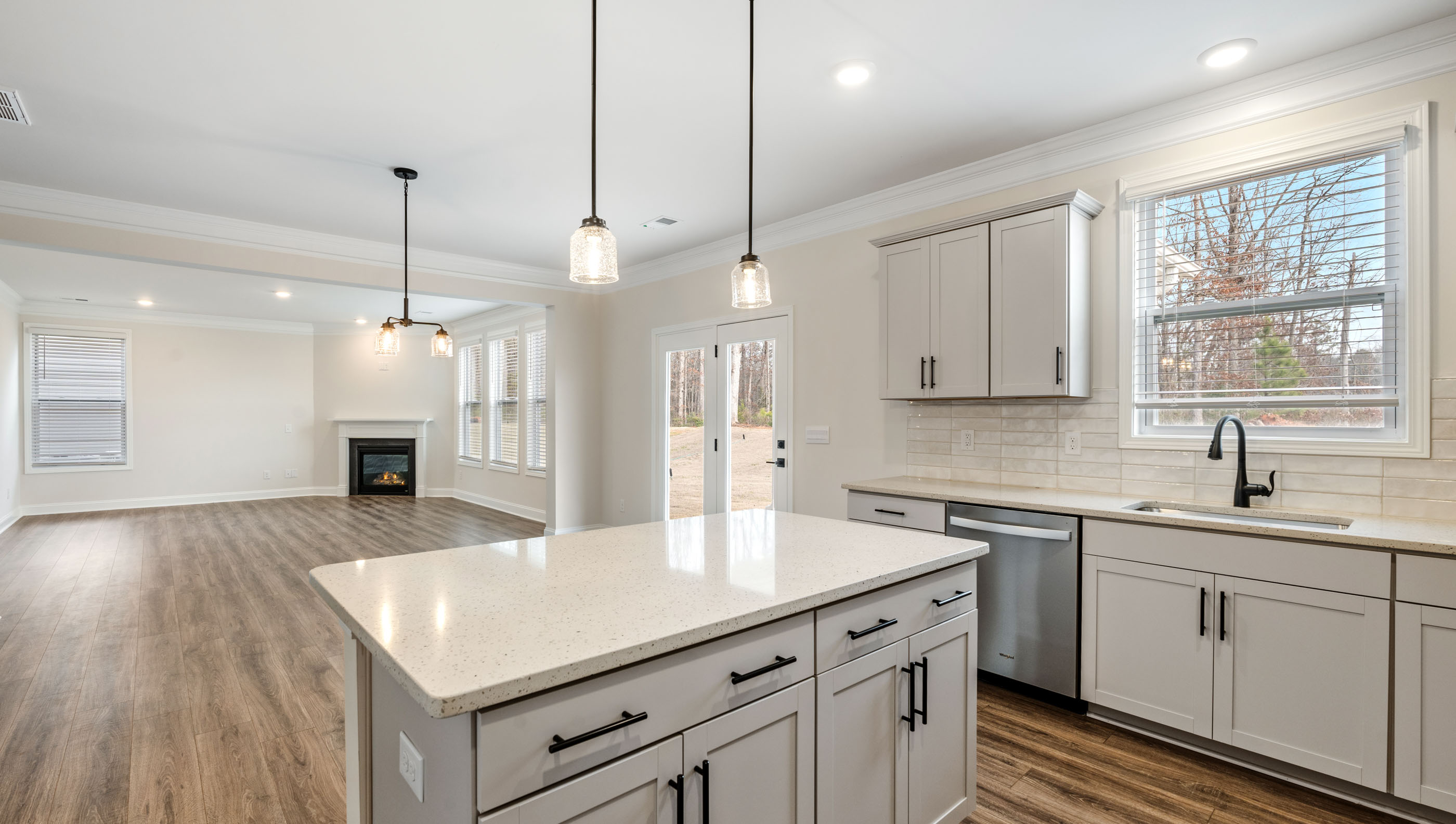Kitchen with island and quartz countertops.