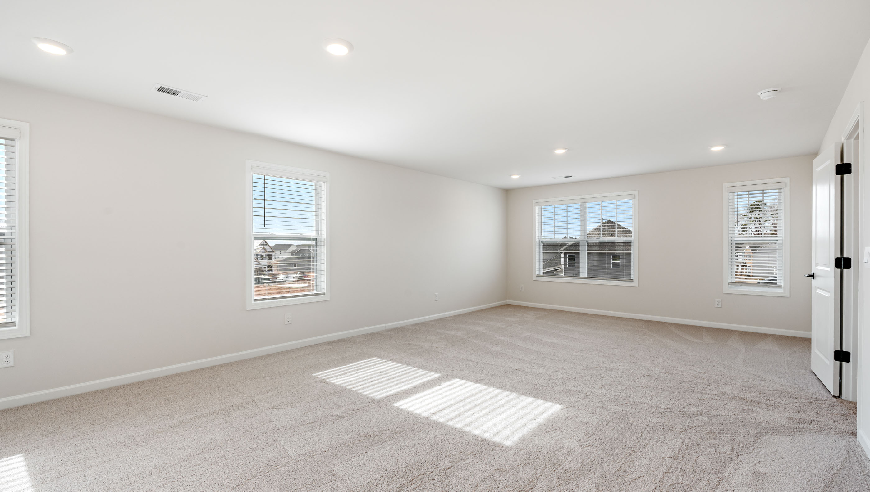 Bedroom with carpet and window.