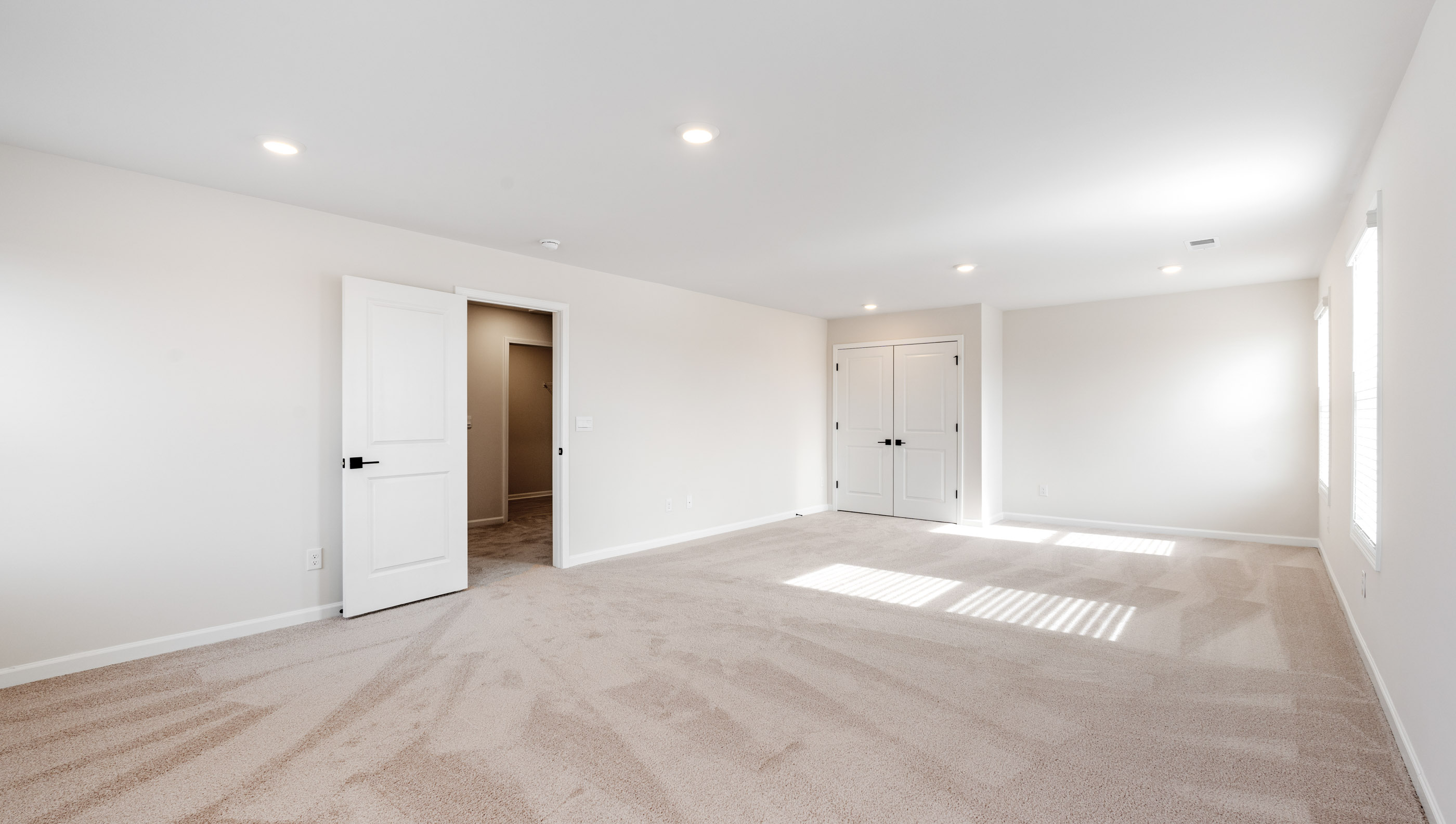 Bedroom with carpet and window.