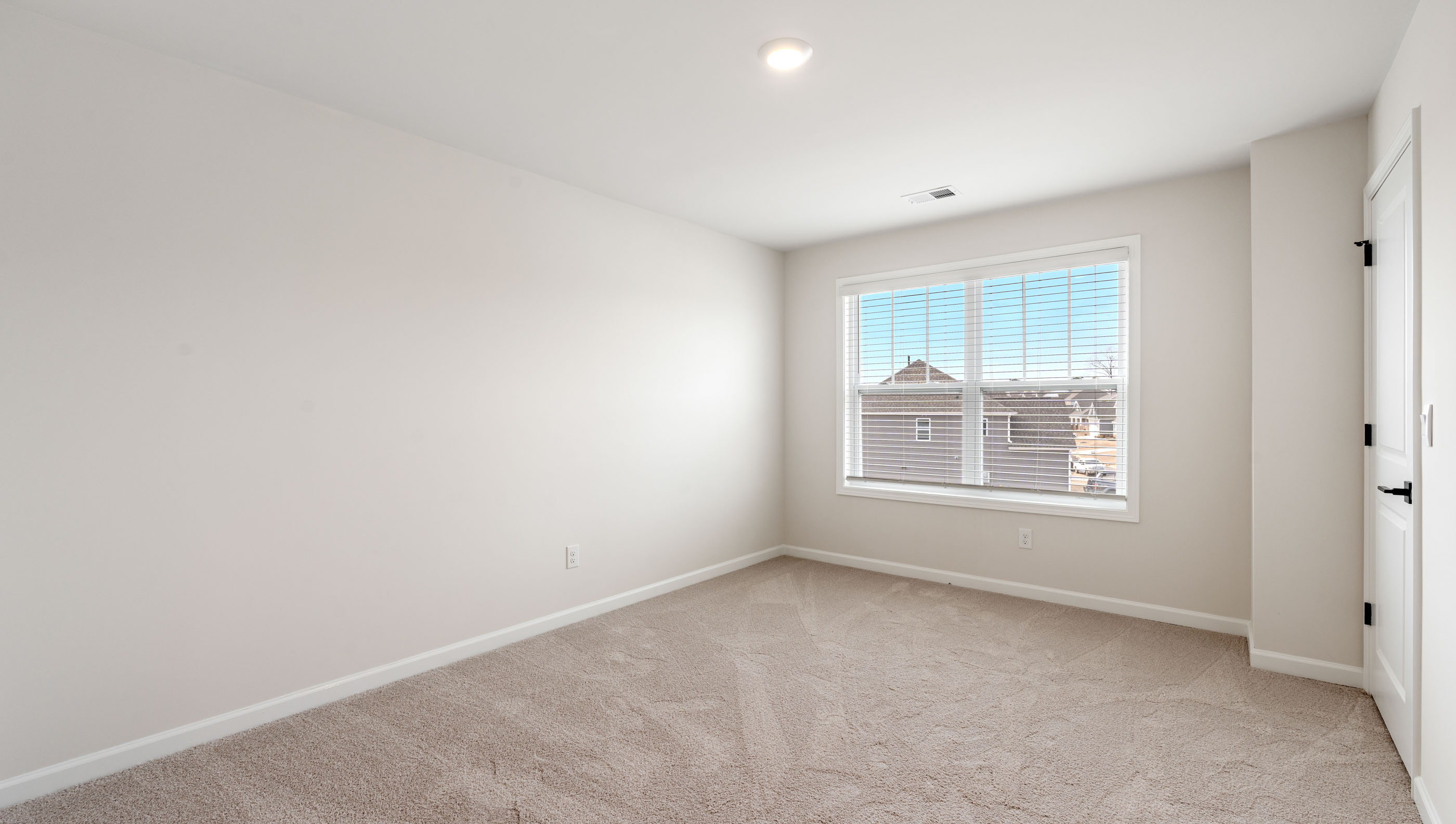 Bedroom with carpet and window.
