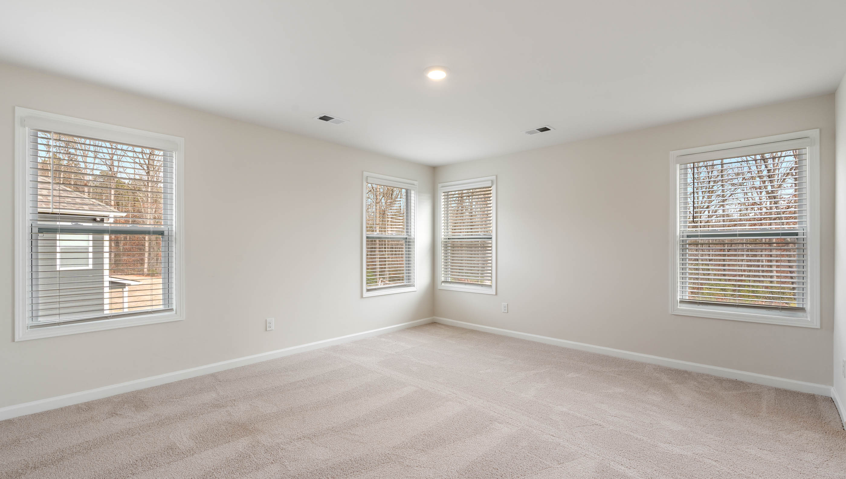 Bedroom with carpet and window.