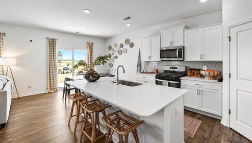 Kitchen and island with granite counter tops.