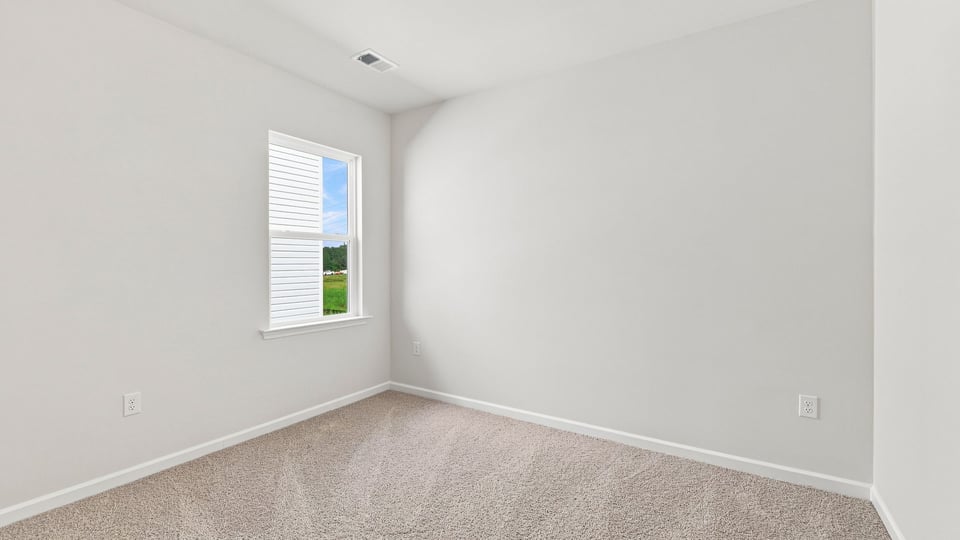 Bedroom with carpet and window.