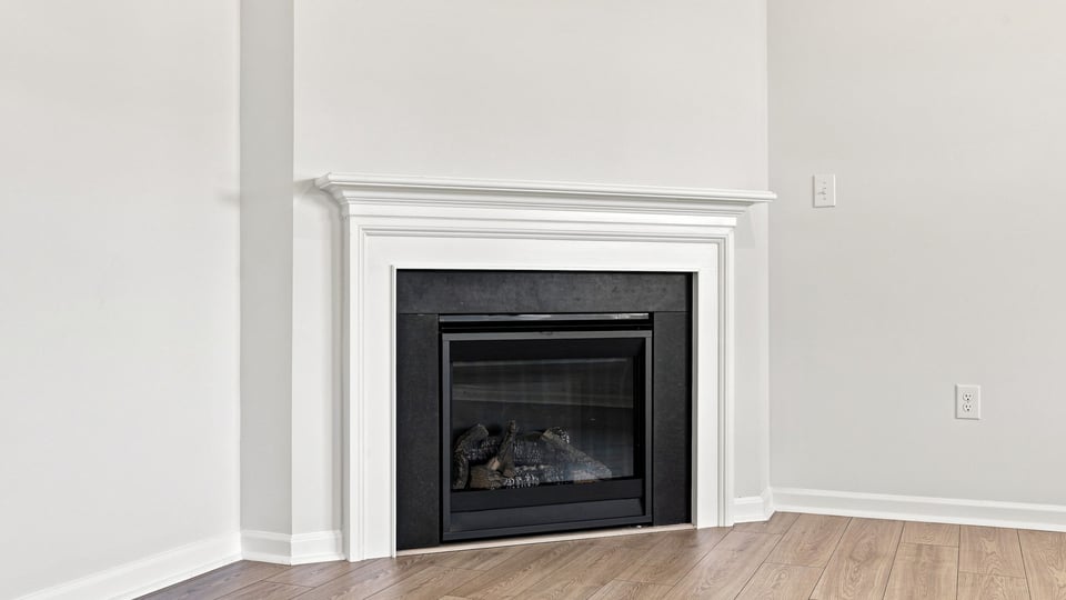 Living area with windows and fireplace.
