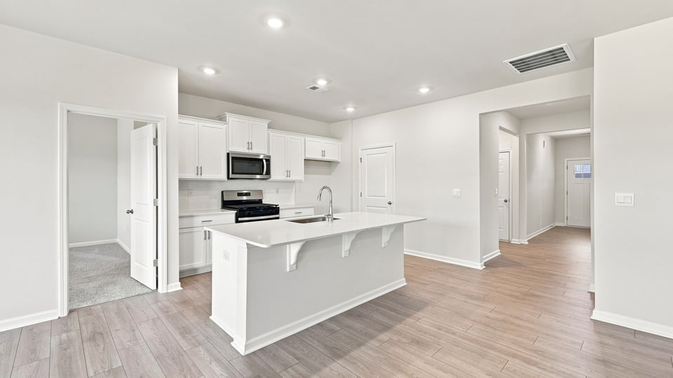 Kitchen with island and cabinets.