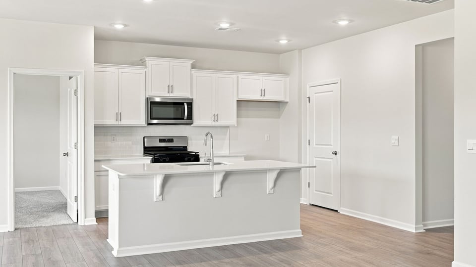 Kitchen with island and cabinets.