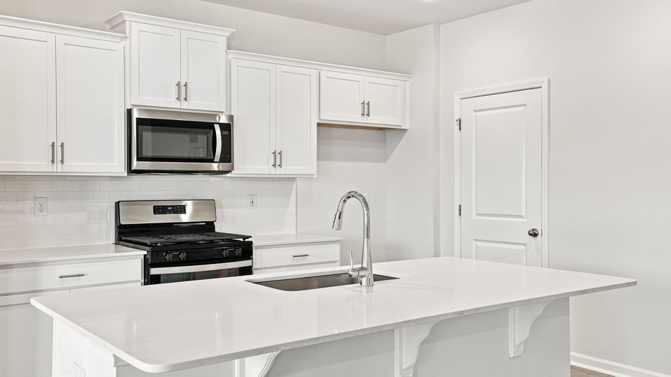 Kitchen with island and cabinets.