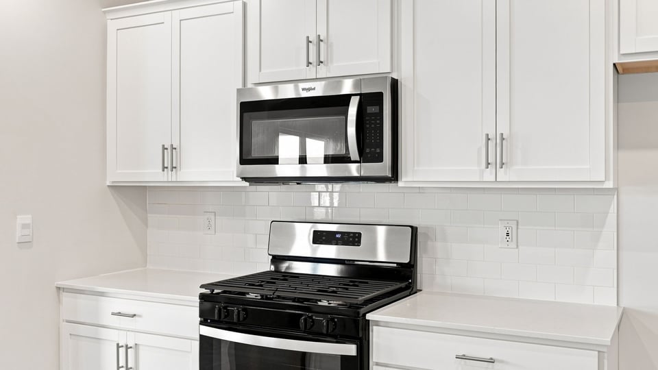 Kitchen with island and cabinets.