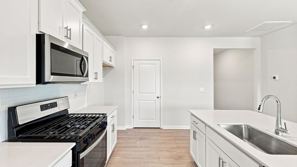 Kitchen with island and cabinets.