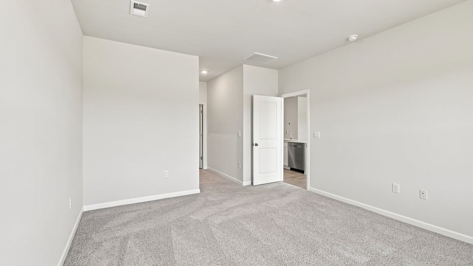 Bedroom with carpet and windows.
