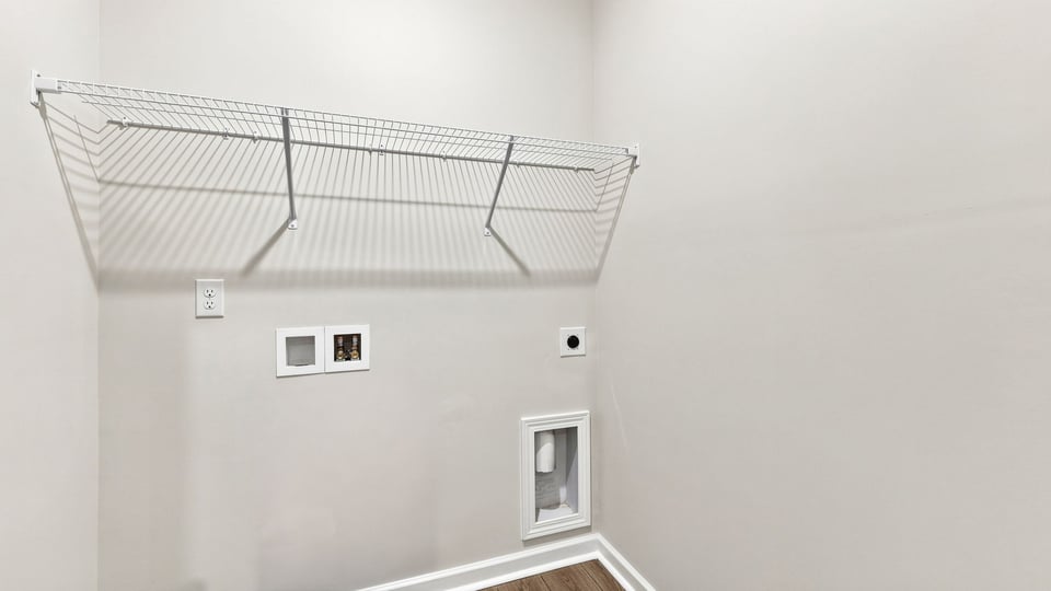 Laundry room with shelf.