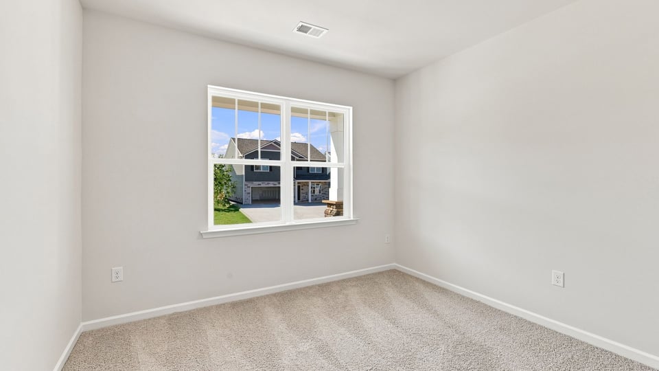 Bedroom with carpet and window.