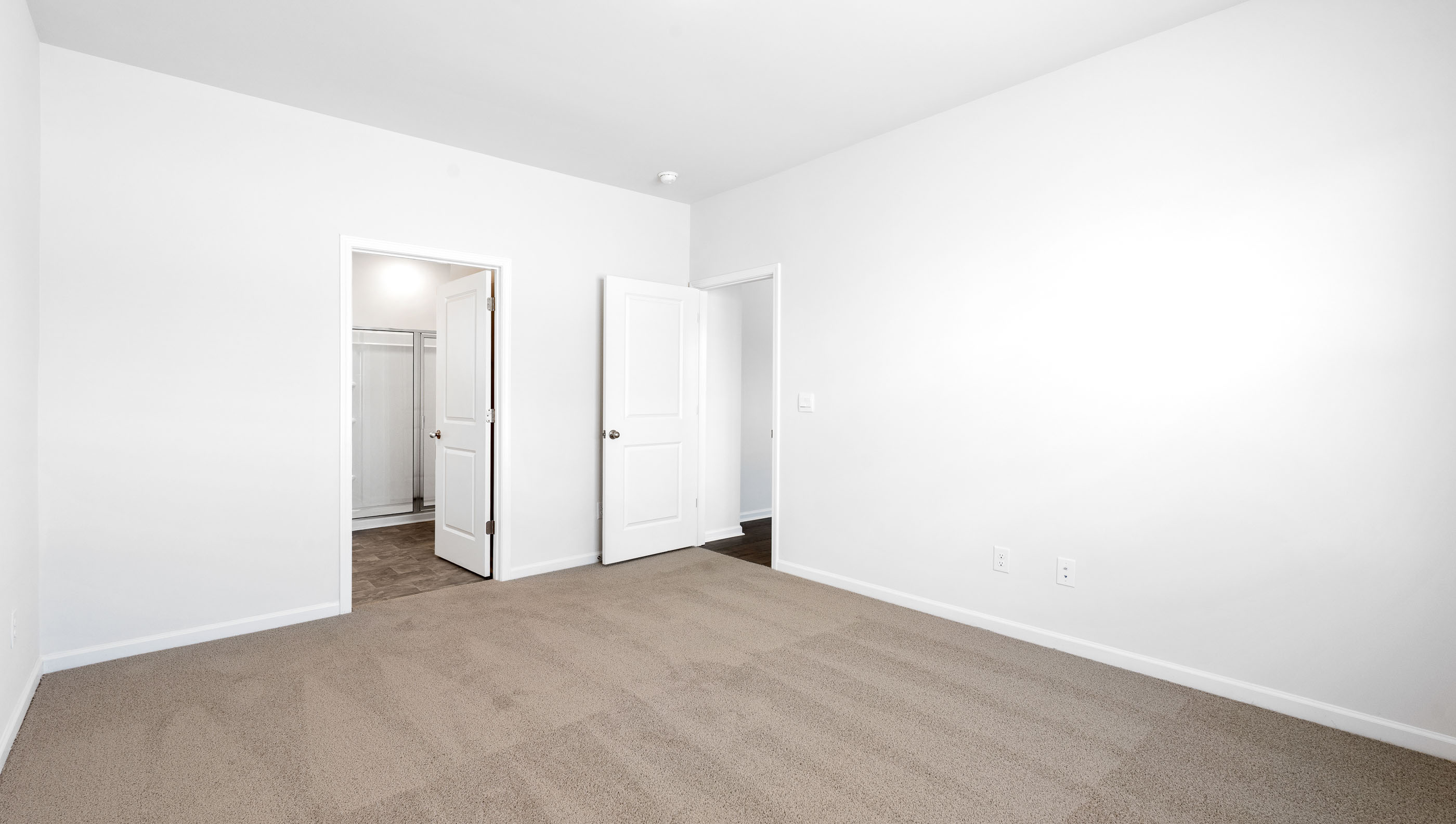 Bedroom with carpet and windows.