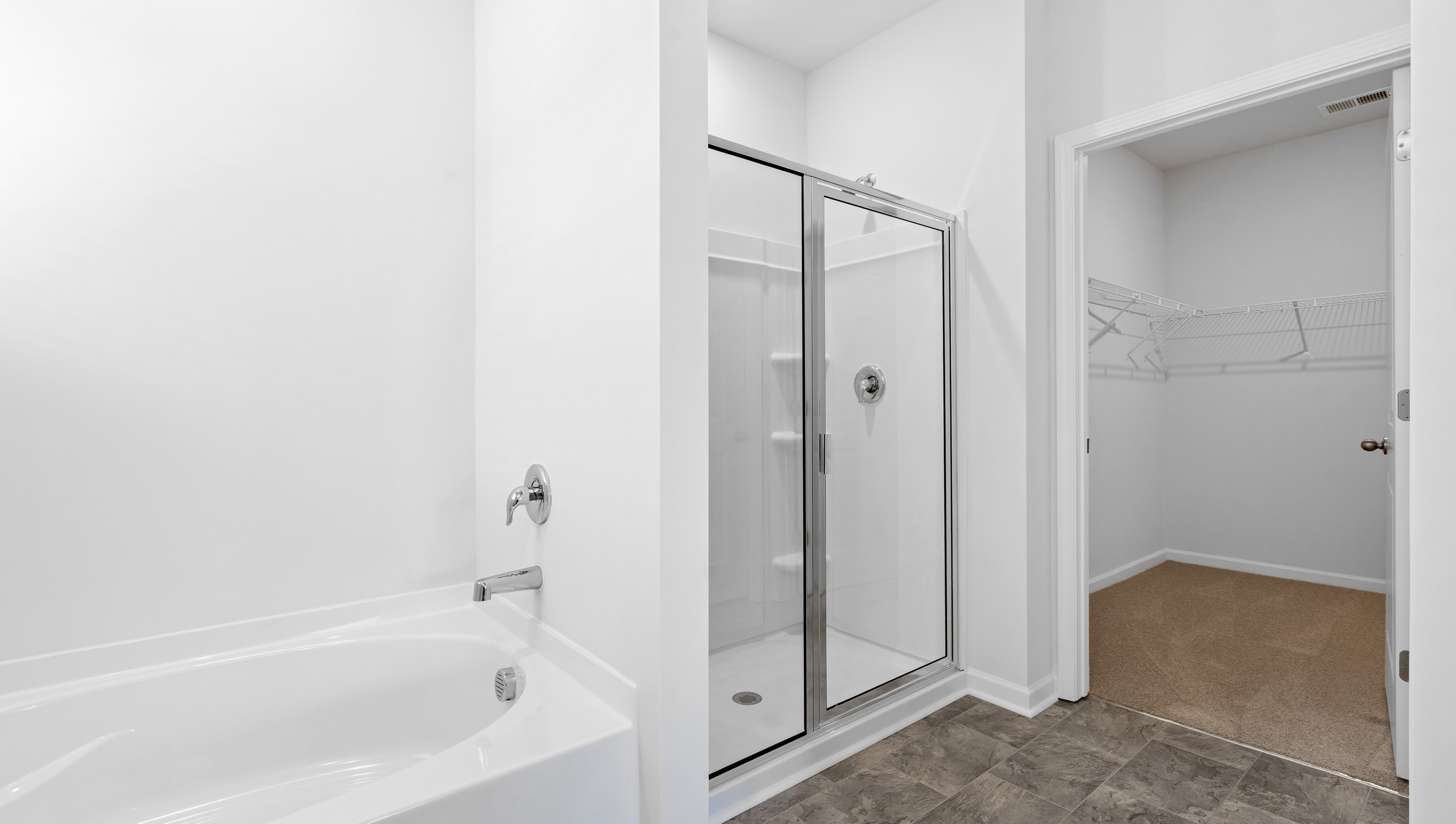 Bedroom with walk in shower and tub.