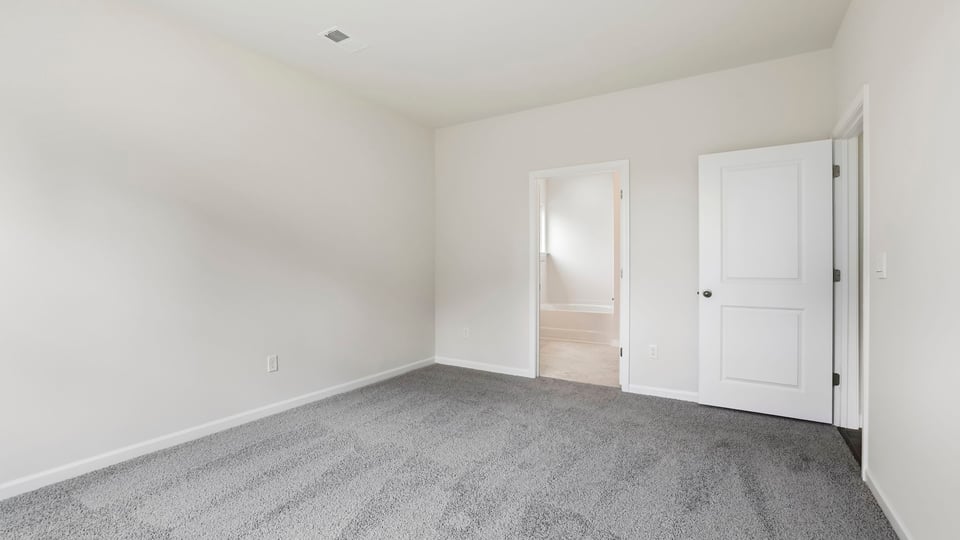 Bedroom with carpet and windows.