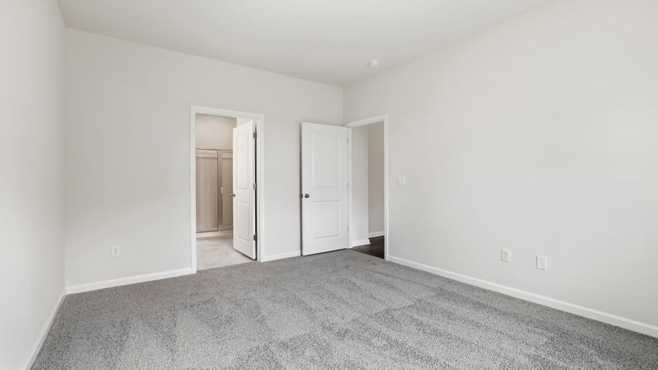 Bedroom with carpet and windows.