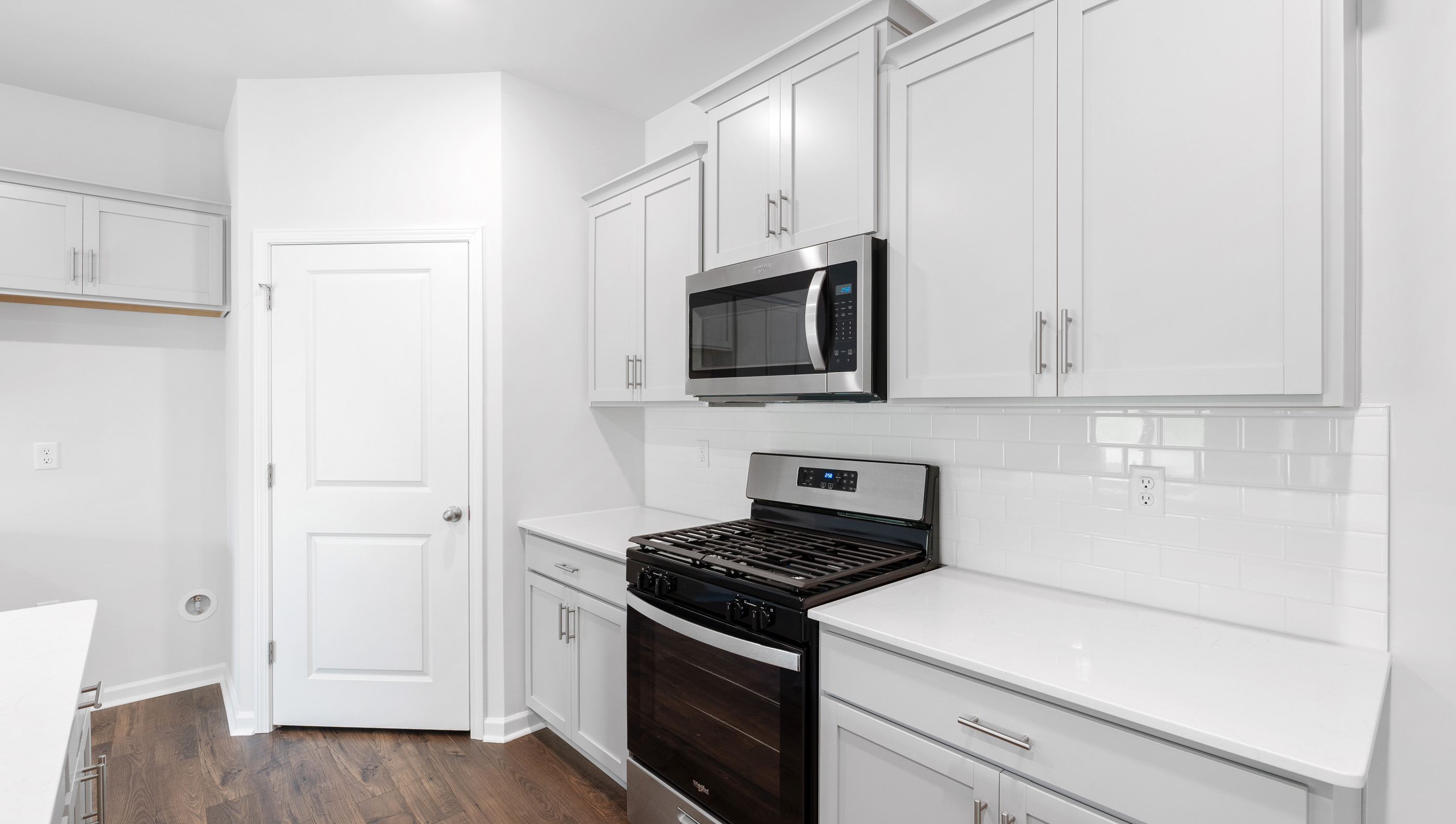 Kitchen with island and quartz countertop.