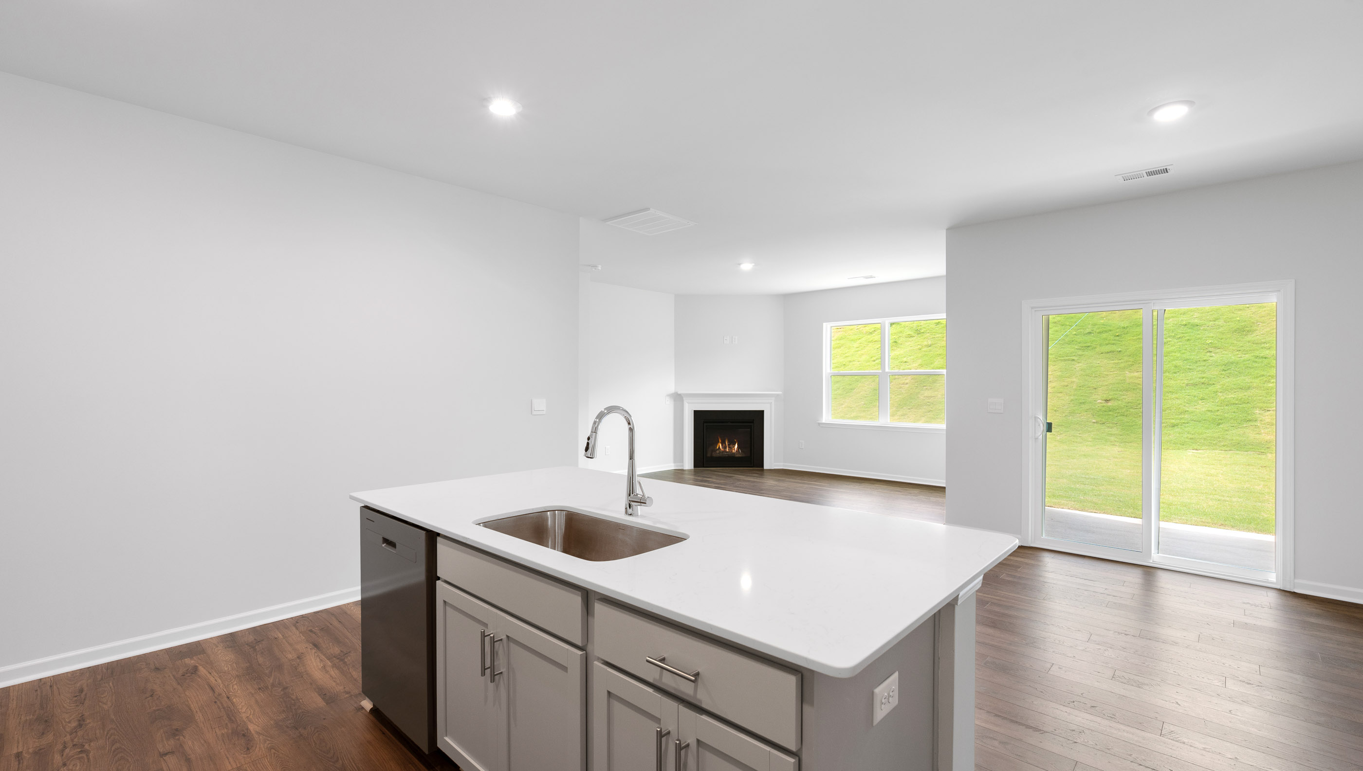 Kitchen with island and quartz countertop.