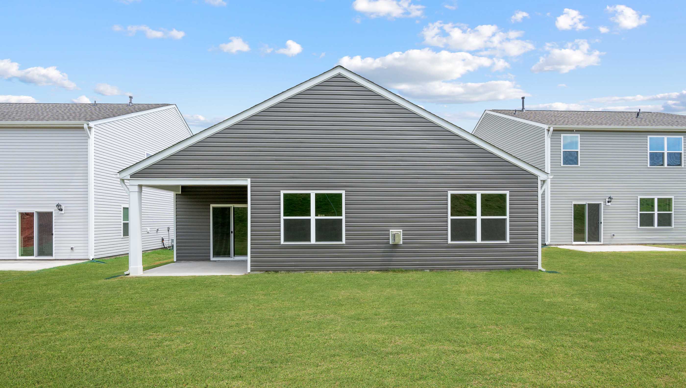 Exterior of house with large backyard.
