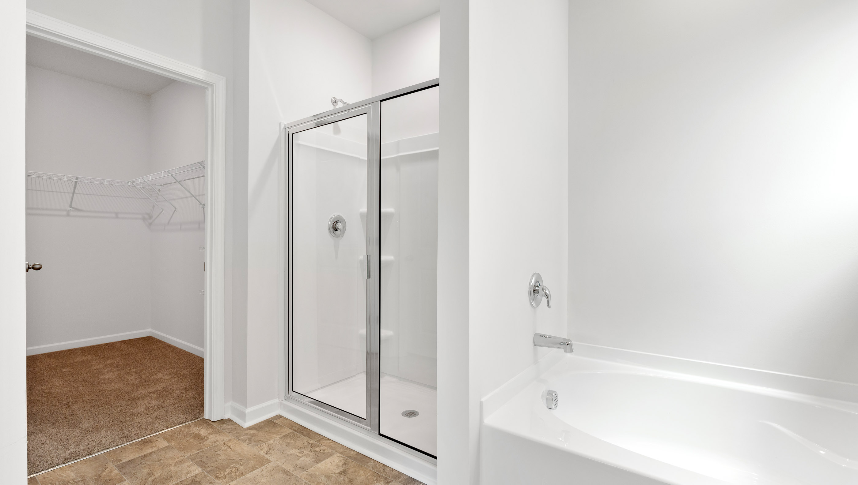 Bathroom with tub and walk in shower.