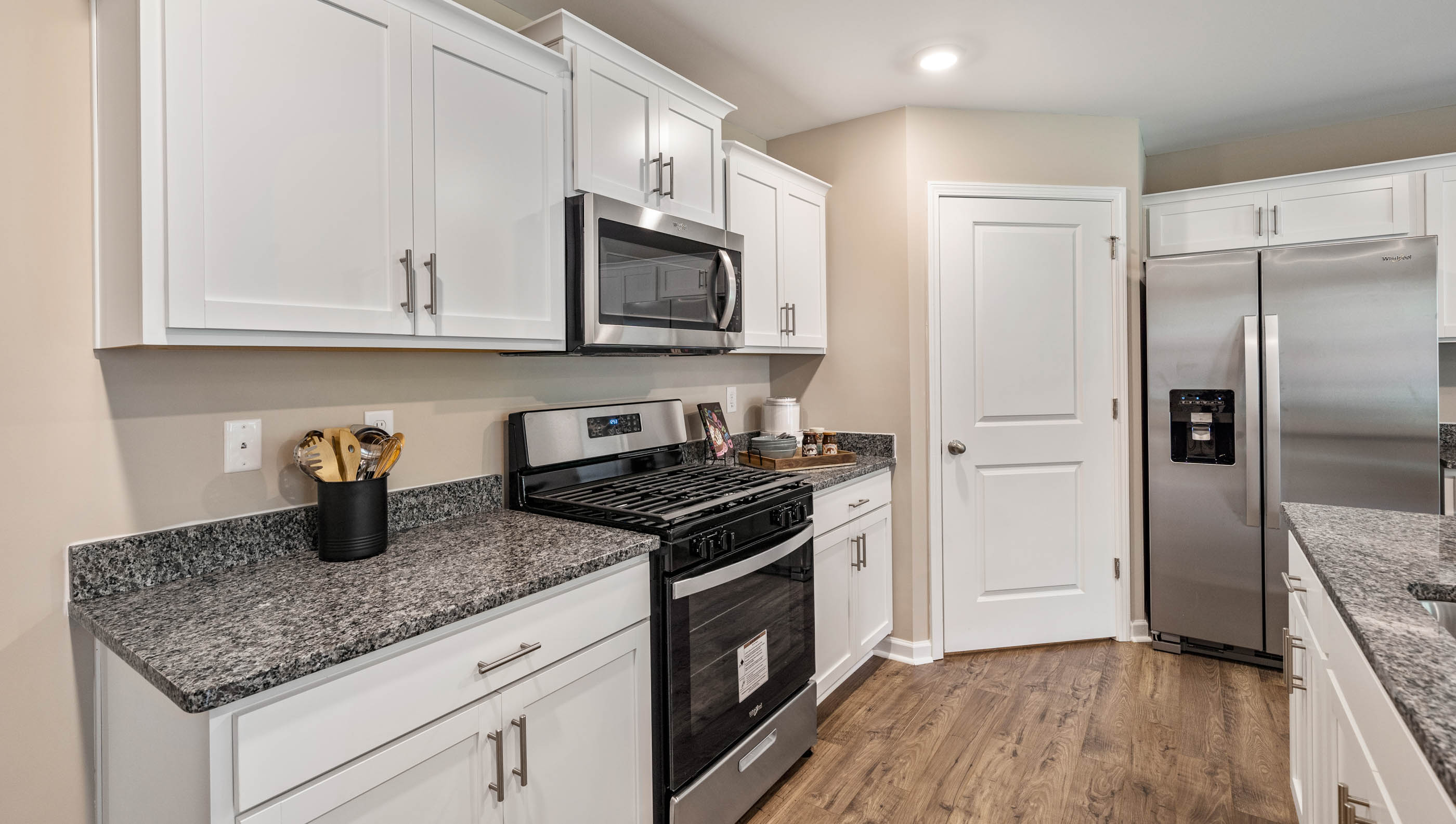 Kitchen and island with granite counter tops.