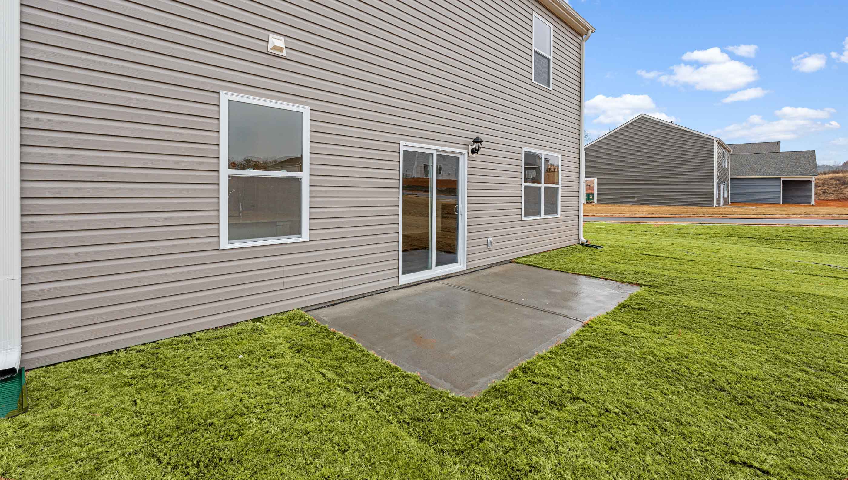 Back exterior of home with patio.