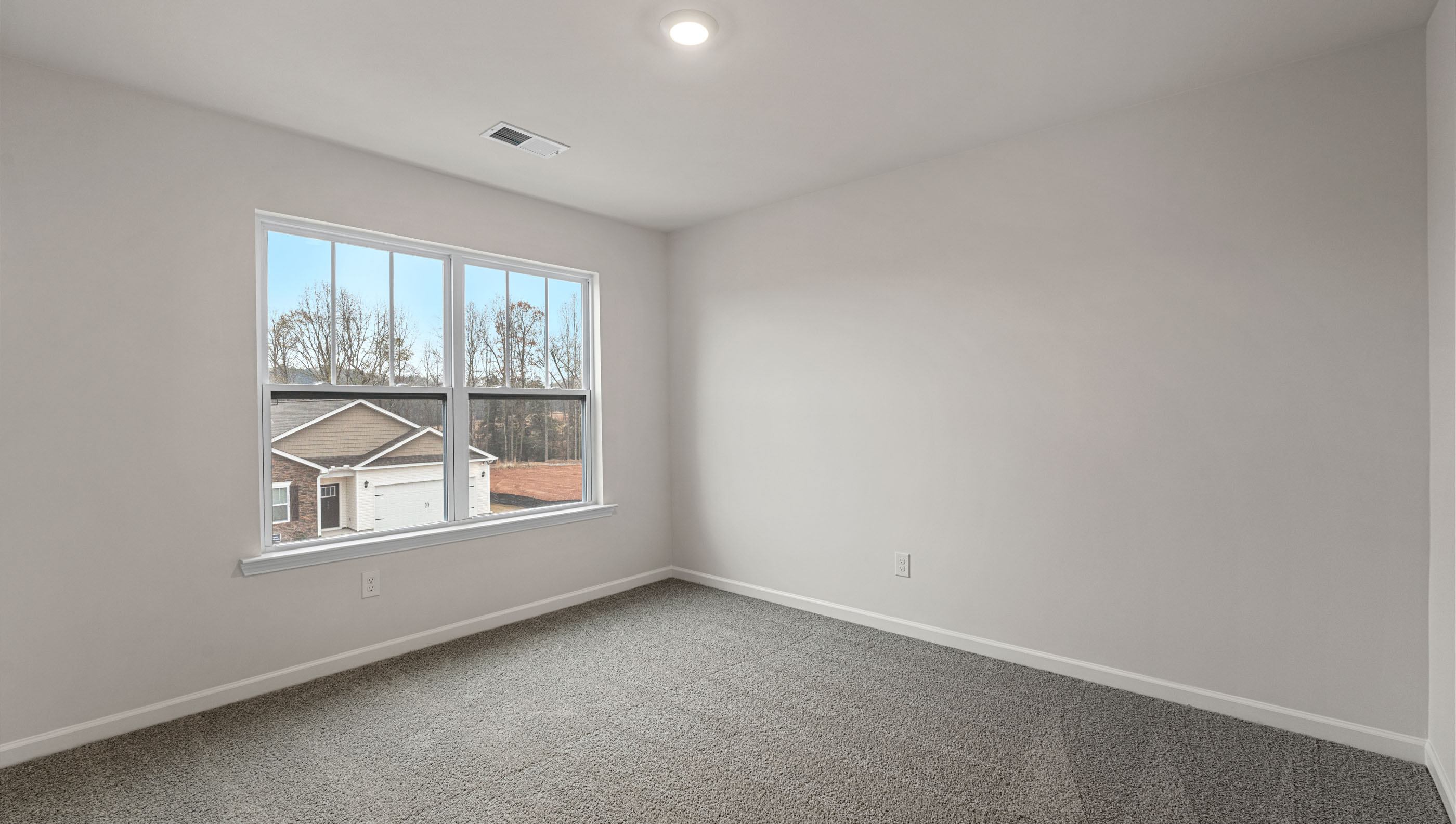 Bedroom with carpet and window.