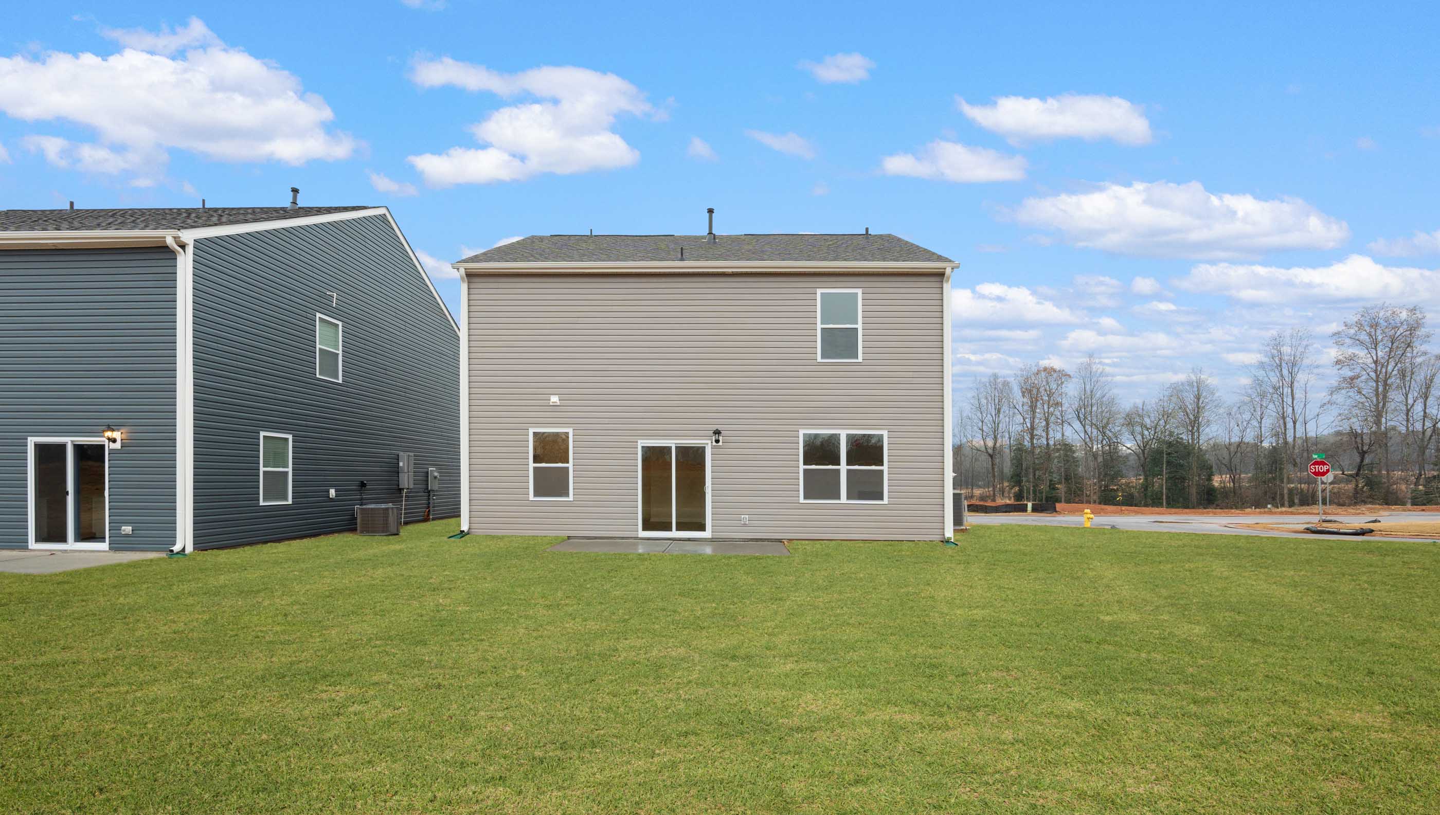 Back exterior of home with large backyard.