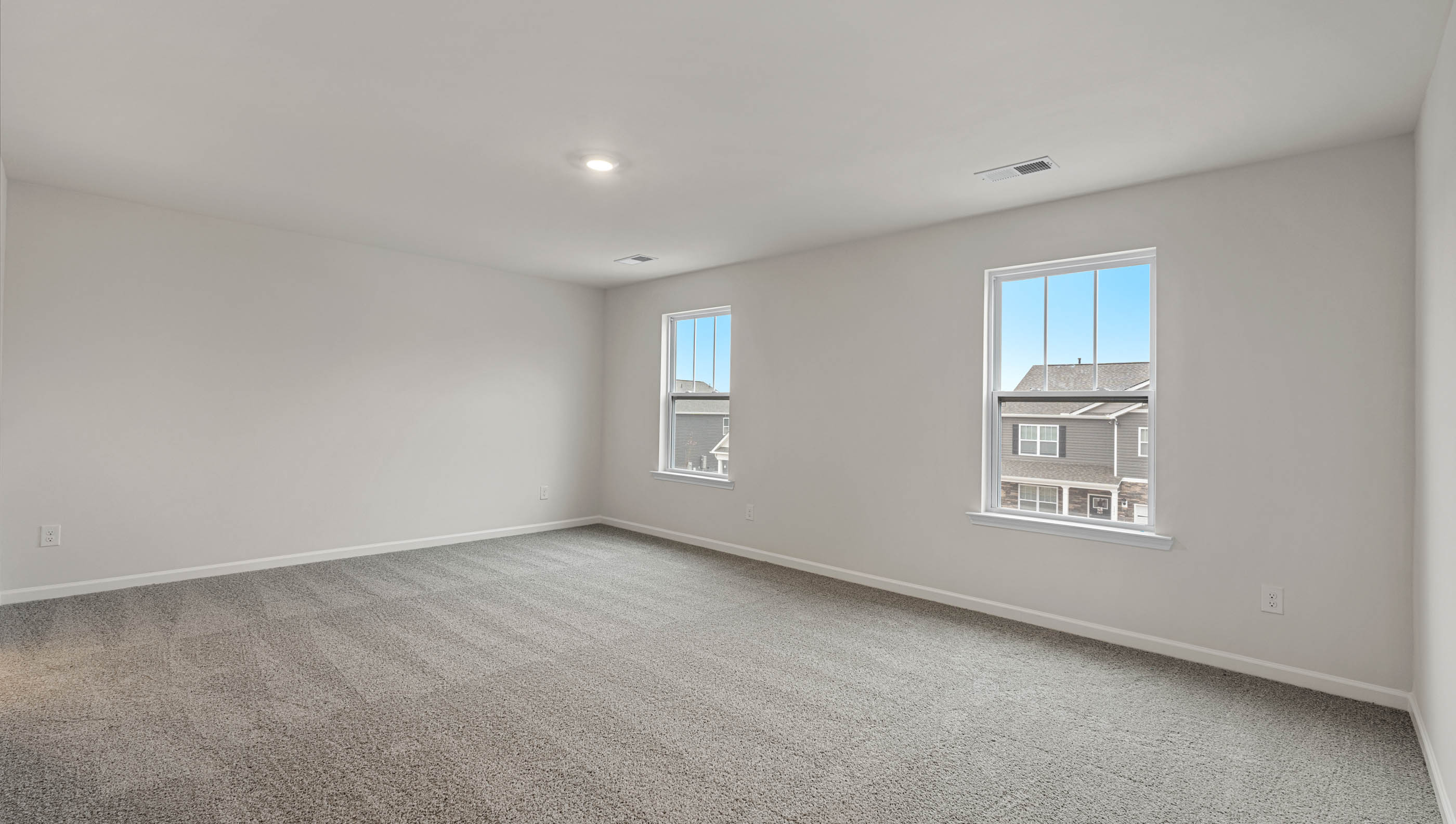 Bedroom with carpet and window.
