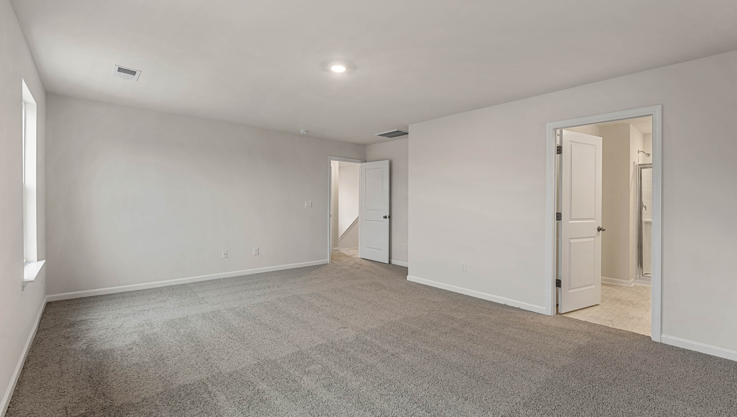 Bedroom with carpet and window.