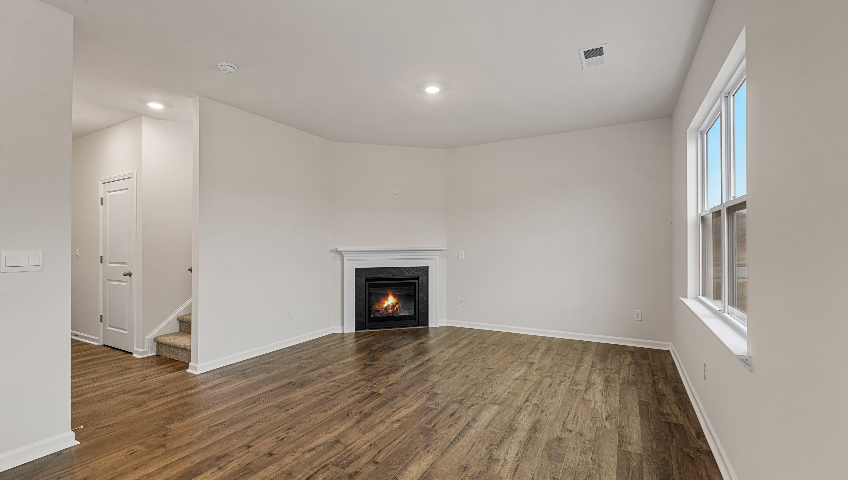 Family room with windows and fireplace.