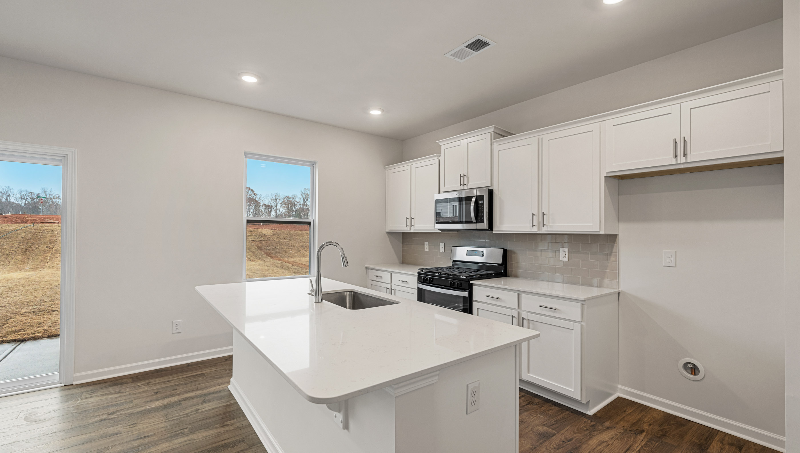 Kitchen and island with quartz countertops.