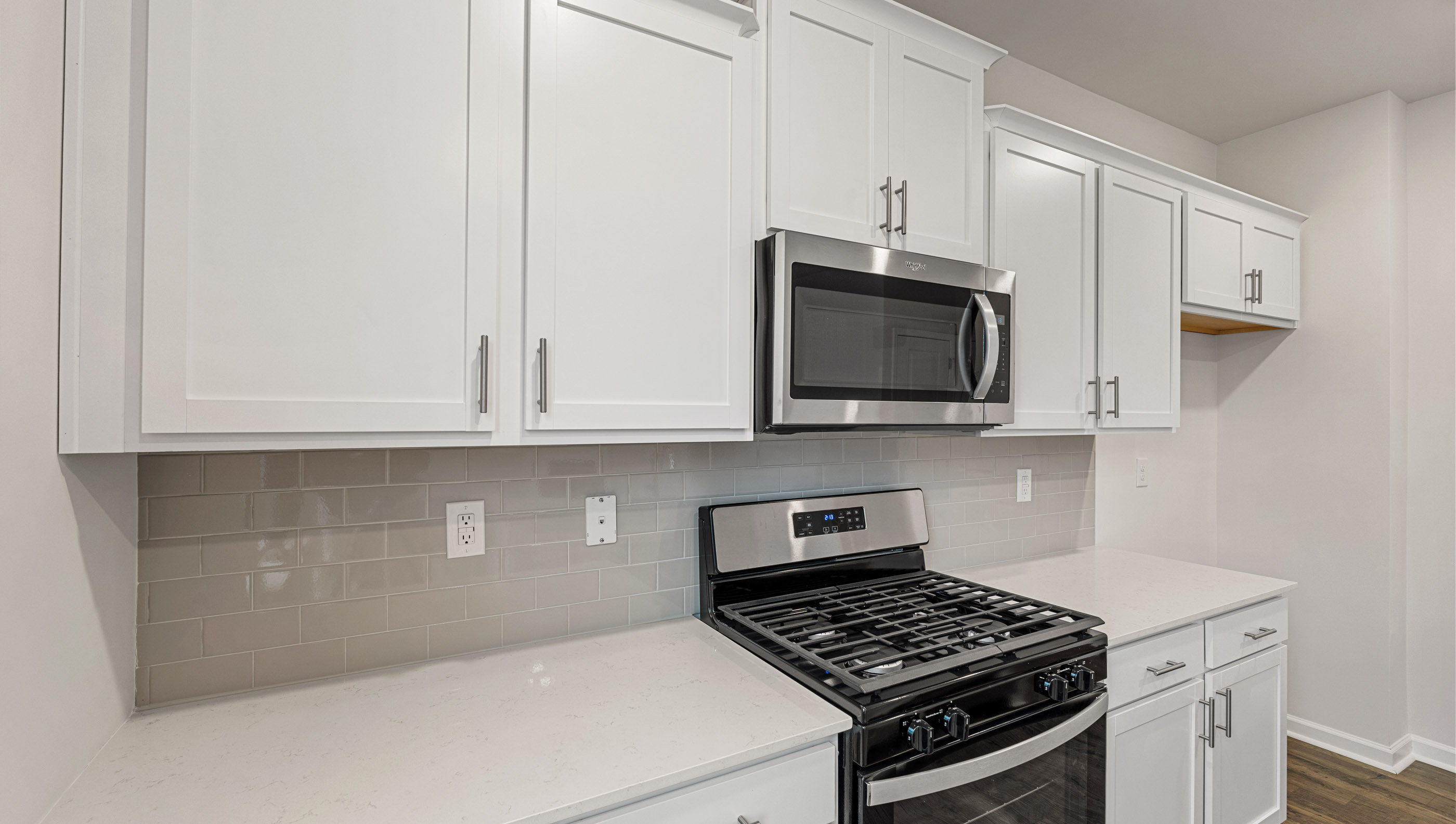 Kitchen and island with quartz countertops.