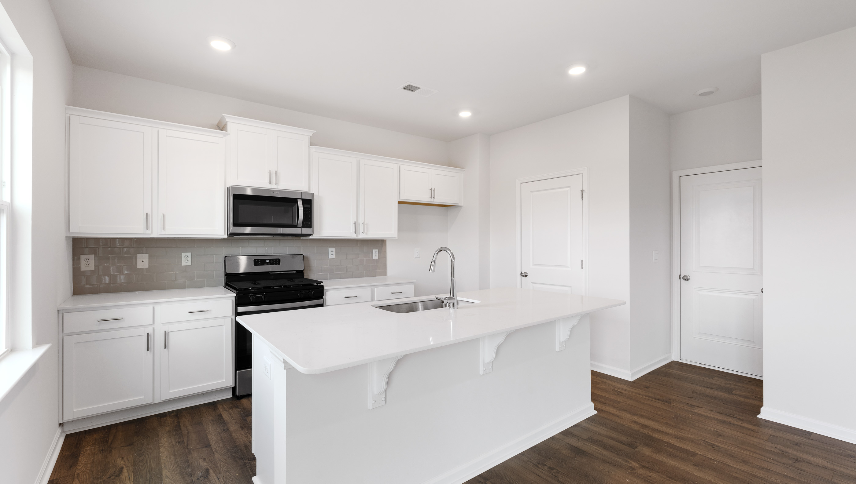 Kitchen with island and granite countertops.