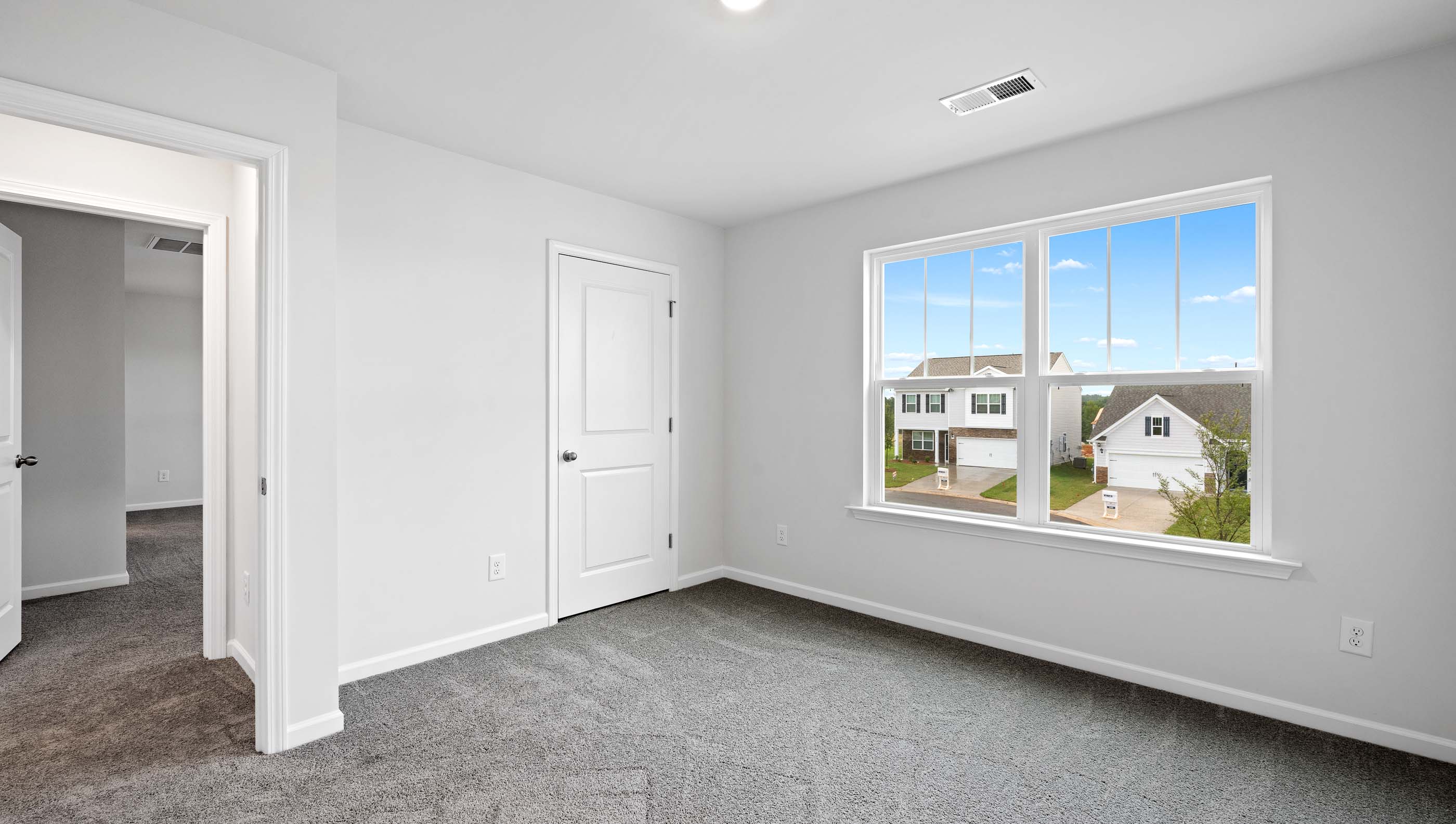 Bedroom with carpet and windows.