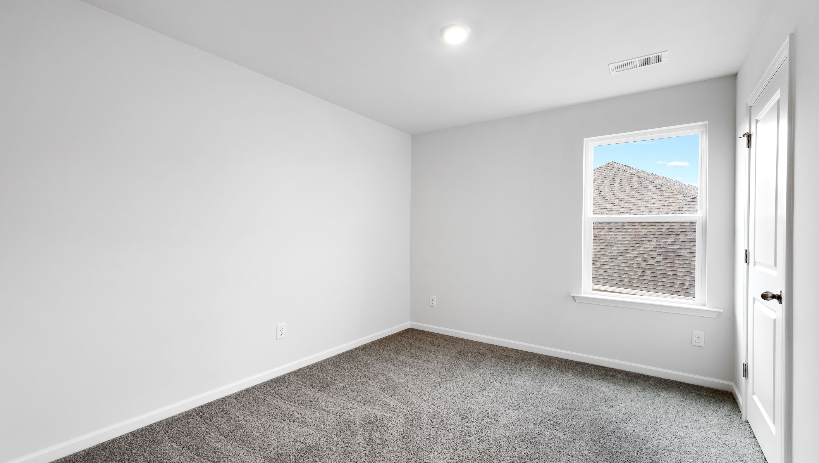 Bedroom with carpet and windows.