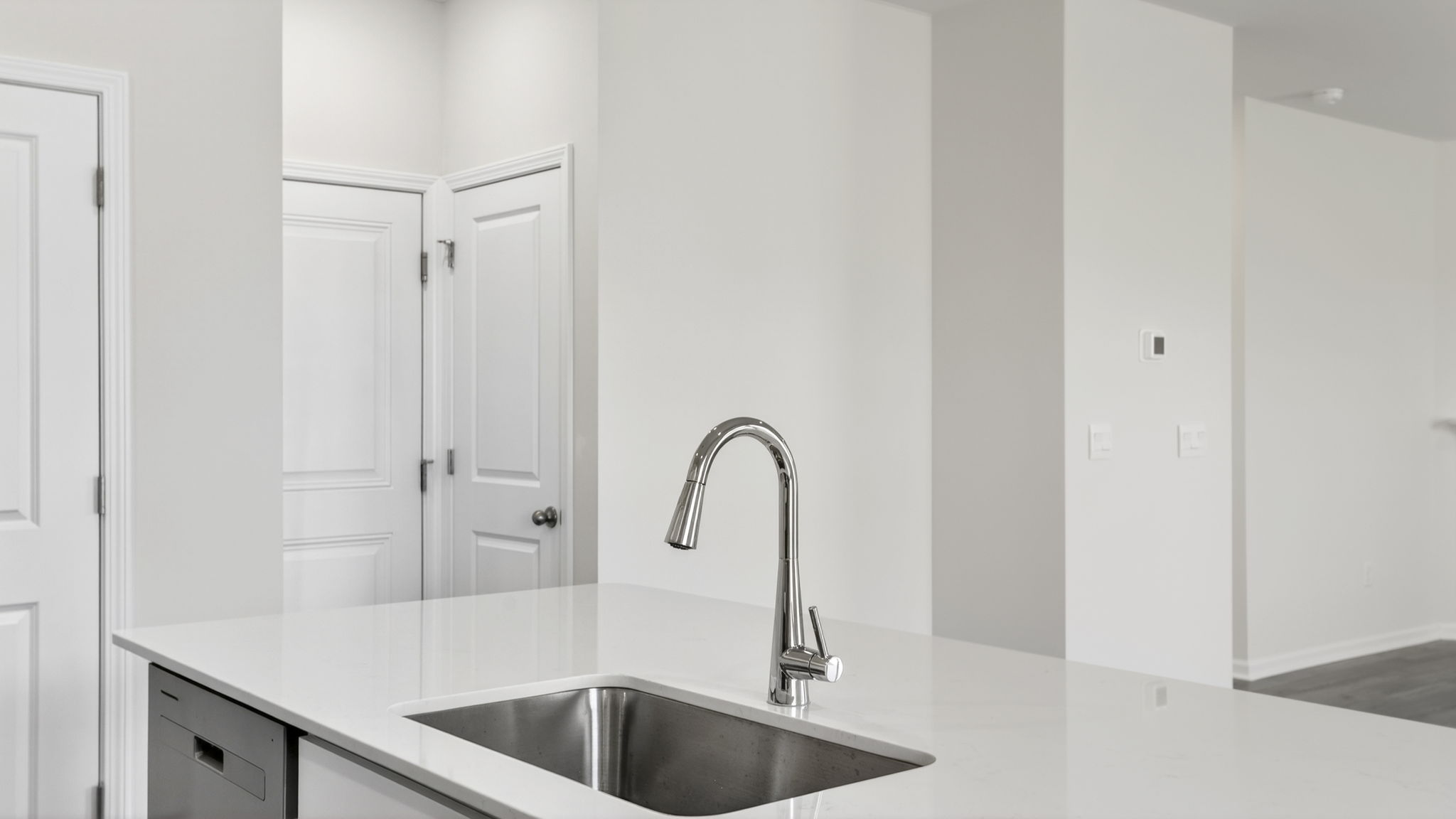 Kitchen and island with quartz counter tops and stainless steel appliances.