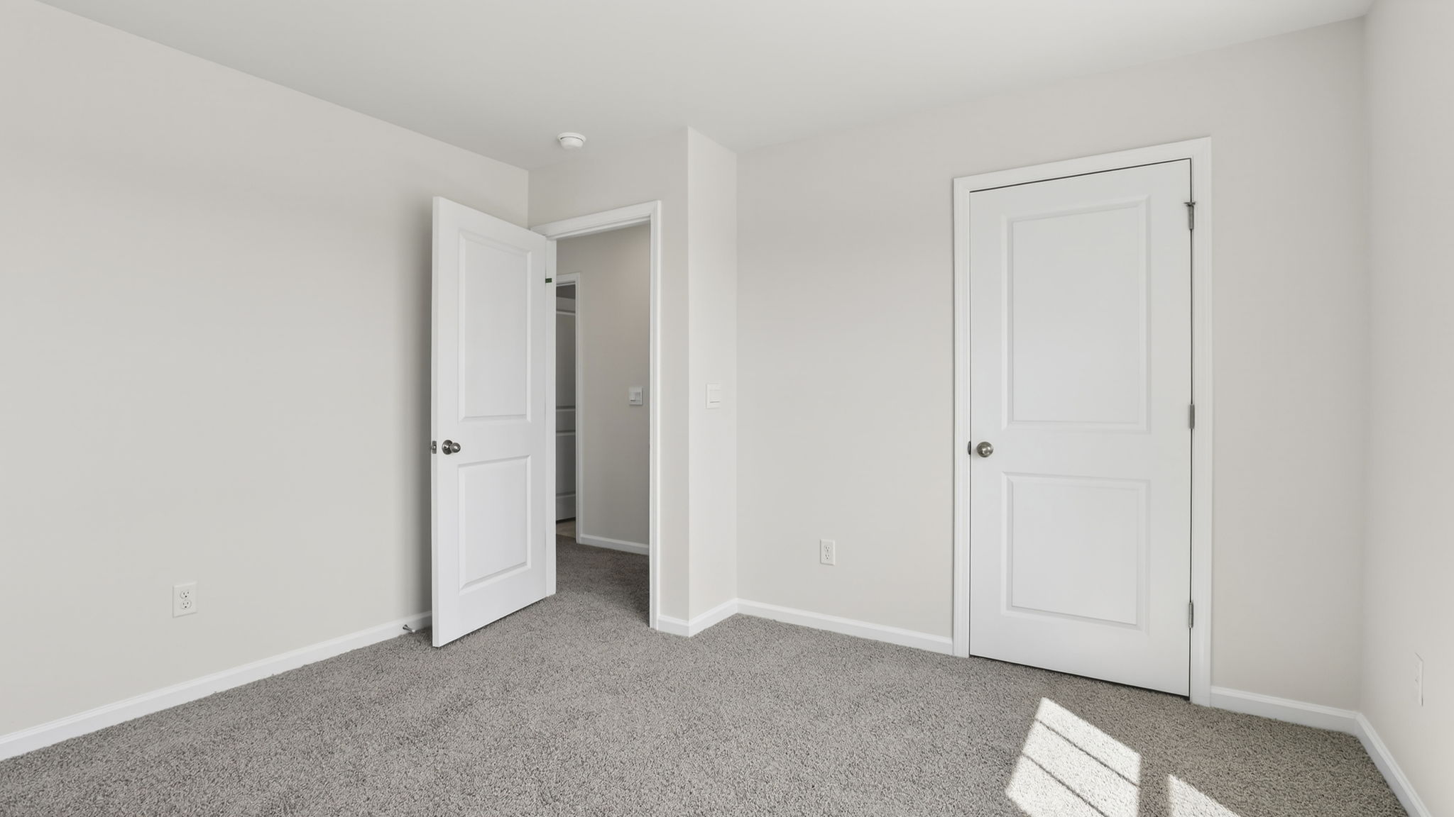 Bedroom with carpet and windows.