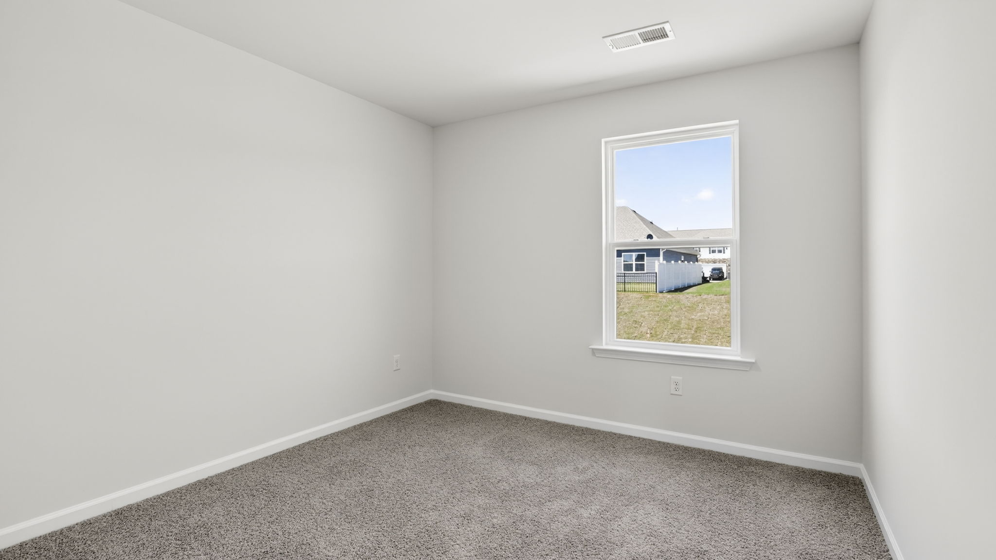 Bedroom with carpet and windows.