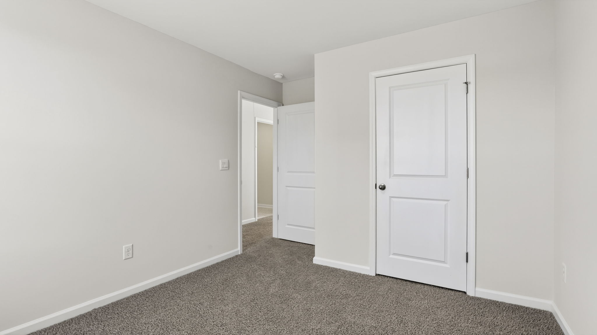 Bedroom with carpet and windows.