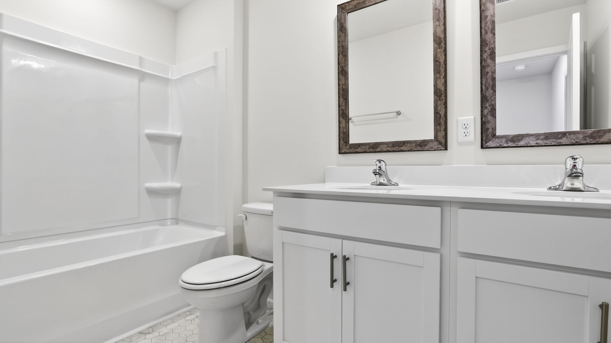 Bathroom with double vanity sink and tub.