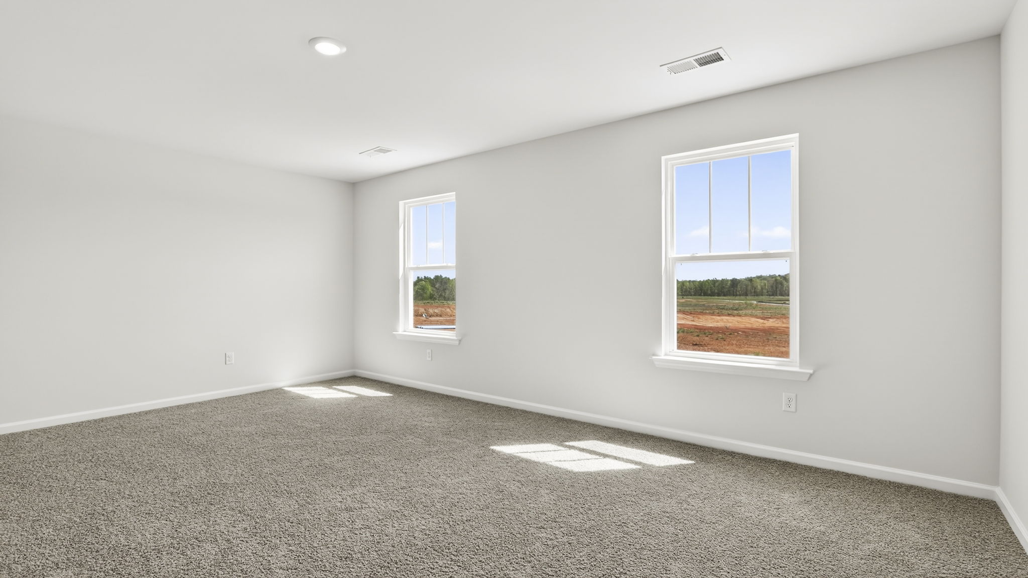 Bedroom with carpet and windows.